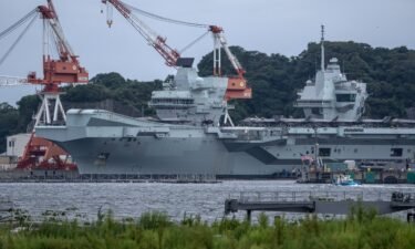Royal Navy warships leave Britain for a five-year deployment. Pictured is the British Royal Navy aircraft carrier HMS Queen Elizabeth docked at Yokosuka Naval Base in Japan on September 5.