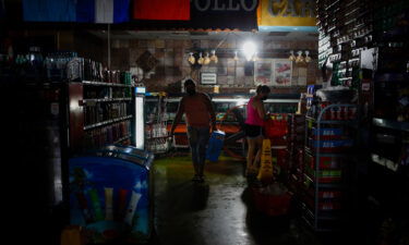Shoppers buy supplies at a grocery store during the blackout after Hurricane Ida in New Orleans
