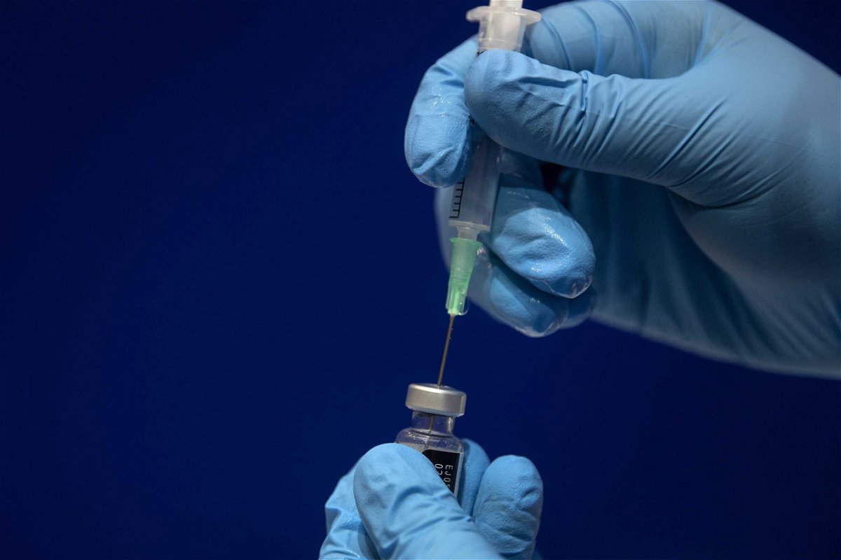 <i>Victoria Jones/Pool/Getty Images</i><br/>Sodium chloride is added to a vial of the Pfizer/BioNTech COVID-19 vaccine concentrate ready for administration at Guy's Hospital at the start of the largest ever immunization program in the UK's history in 2020 in London