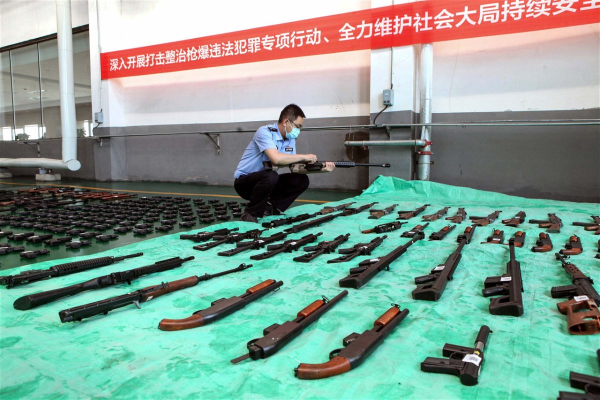 <i>STR/AFP/Getty Images</i><br/>A police officer inspects confiscated illegal guns slated for destruction at an incineration facility in Shenyang