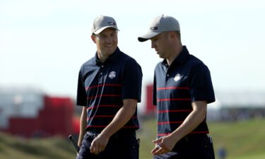 Jordan Spieth and Thomas walk during Friday Morning Foursome Matches of the 43rd Ryder Cup.