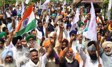 Farmers shout slogans in protest against the government's agricultural reforms