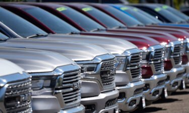 A lone line of unsold 2021 pickup trucks in an empty storage lot at a Dodge Ram dealership on Sept. 12 in Littleton