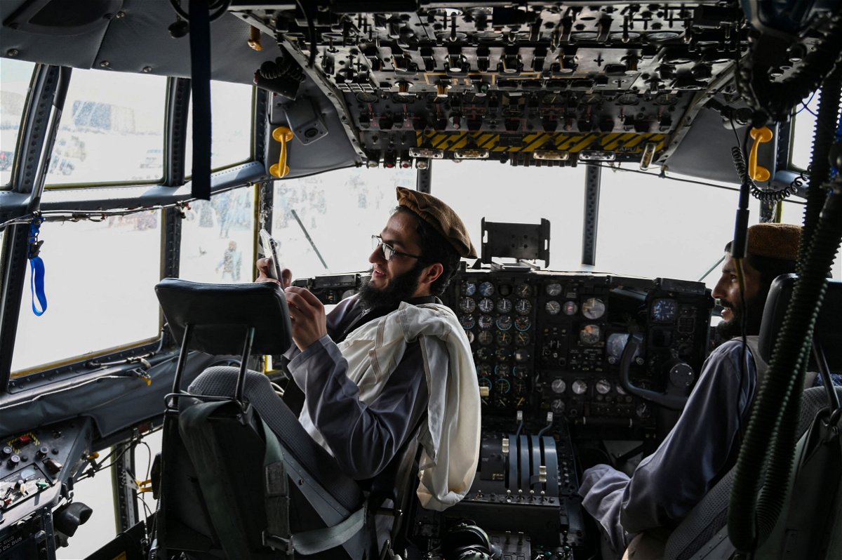 <i>Wakil Kohsar/AFP/Getty Images</i><br/>Taliban fighters sit in the cockpit of an Afghan Air Force aircraft at the airport in Kabul on August 31.