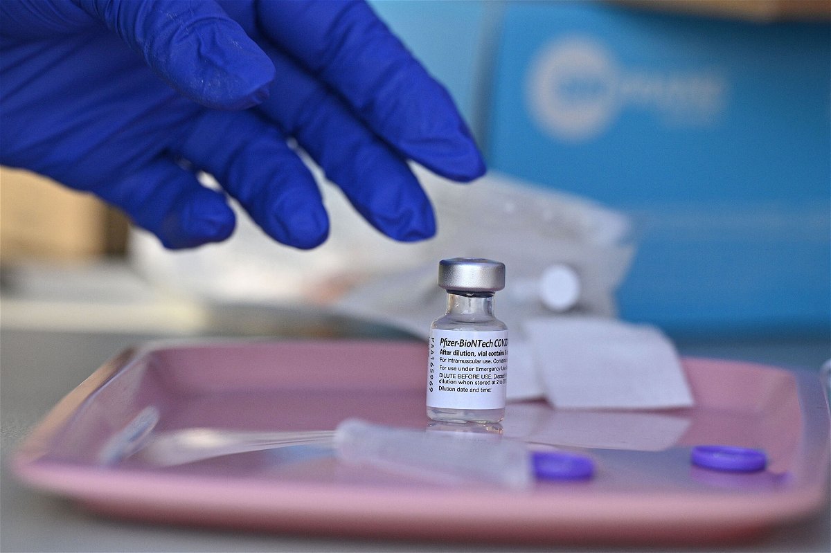 <i>Robyn Beck/AFP/Getty Images</i><br/>A nurse reaches for a vial of Pfizer-BioNTech Covid-19 vaccine at a pop-up vaccine clinic in Los Angeles