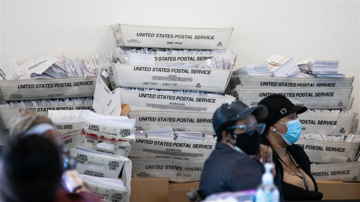<i>Jessica McGowan/Getty Images</i><br/>Security envelopes for absentee ballots sit in stacked boxes as Fulton County workers continue to count absentee ballots at State Farm Arena on November 6