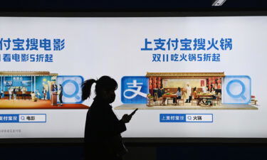 Shares in Alibaba slumped again on Monday after report that China to break up Alipay. Pictured is an Alipay advertising billboard in Beijing on October 27
