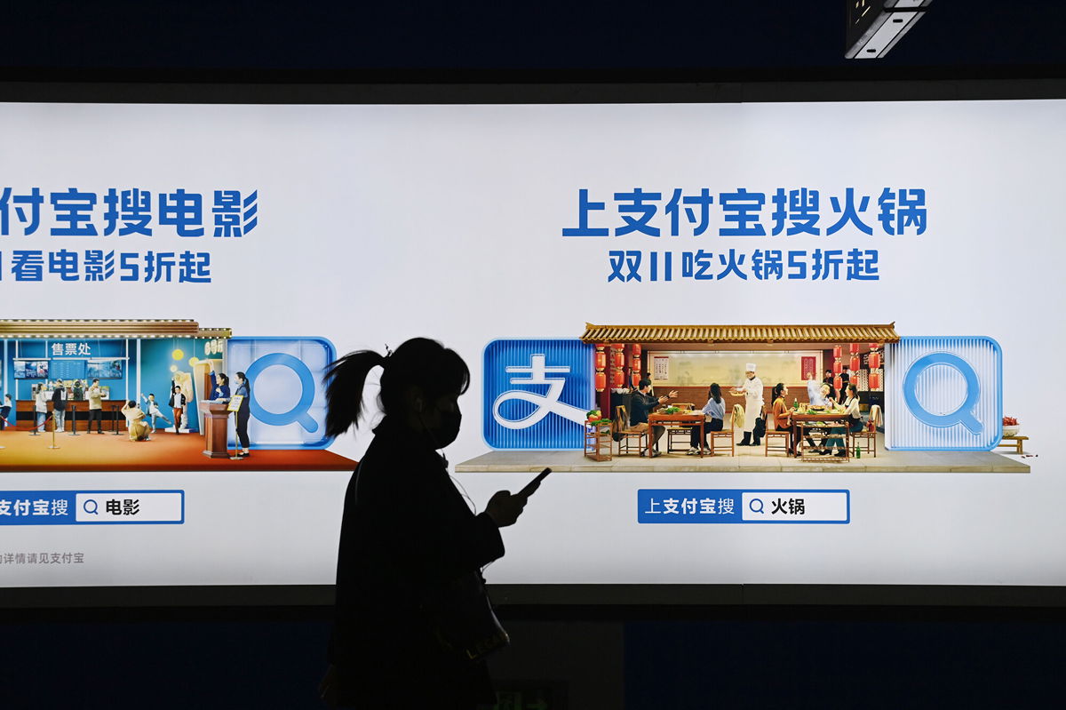 <i>Greg Baker/AFP/Getty Images</i><br/>Shares in Alibaba slumped again on Monday after report that China to break up Alipay. Pictured is an Alipay advertising billboard in Beijing on October 27