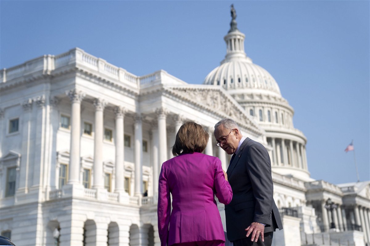 <i>Stefani Reynolds/Bloomberg/Getty Images</i><br/>Senate Majority Leader Chuck Schumer speaks to House Speaker Nancy Pelosi outside the Capitol in June.