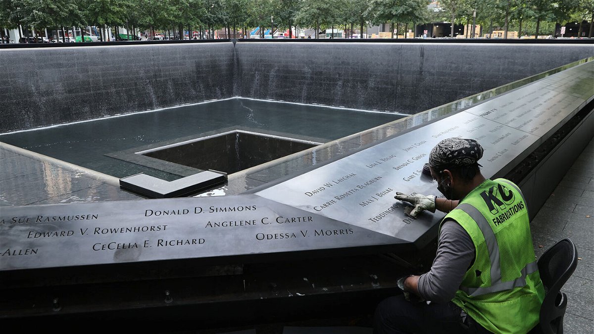 <i>Chip Somodevilla/Getty Images</i><br/>Polishing work is done on the bronze parapets surrounding the twin Memorial pools. A new CNN Poll finds that 57% of Americans say the attacks impacted the way they live their life today.