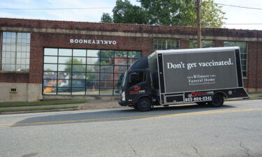 A black truck advertising for "Wilmore Funeral Home" had a very stark message for the unvaccinated filling the streets of downtown Charlotte Sunday.