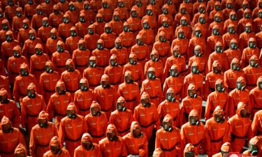Personnel in orange hazmat suits march during a paramilitary parade held to mark the 73rd founding anniversary of the republic in Pyongyang in this undated image supplied by North Korea's Korean Central News Agency on September 9.