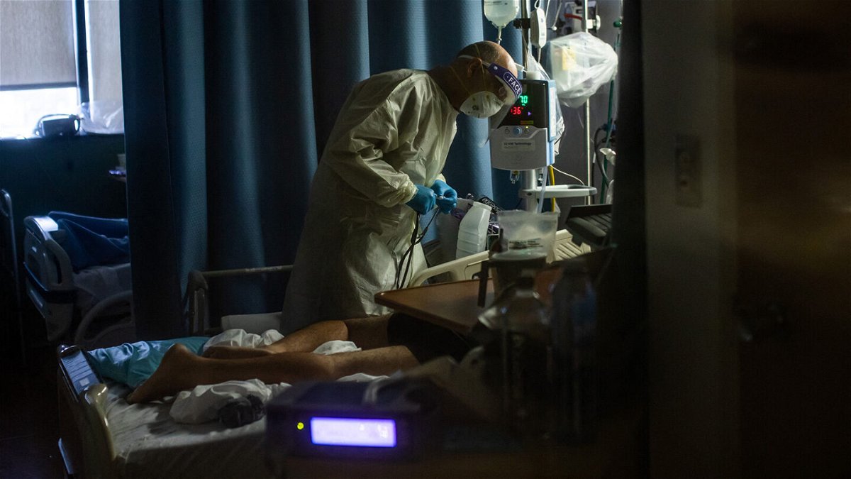 <i>Apu Gomes/AFP/Getty Images</i><br/>A doctor checks on a Covid-19 patient at Providence Cedars-Sinai Tarzana Medical Center in Tarzana