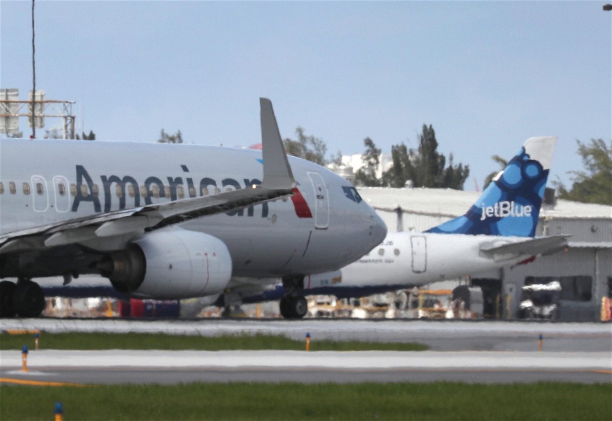 <i>Joe Raedle/Getty Images</i><br/>An American Airlines plane takes off near a parked JetBlue plane at the Fort Lauderdale-Hollywood International Airport on July 16