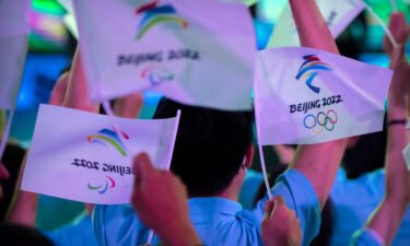 The Beijing 2022 Winter Olympics will be open to spectators -- but only if they live in mainland China. Participants here wave flags with the logos of 2022 Beijing Winter Olympics and Paralympics in Beijing