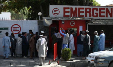 People gather to check on missing relatives a day after a twin suicide bombs attack