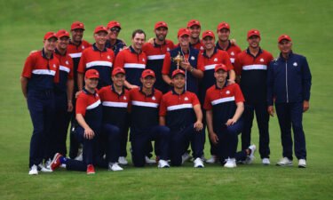 Team US celebrates with the Ryder Cup after defeating Team Europe.