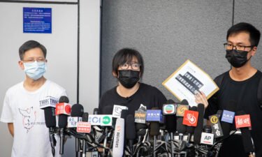 Chow Hang-tung and two other committee members of the Hong Kong Alliance at a press conference in Hong Kong on September 7.