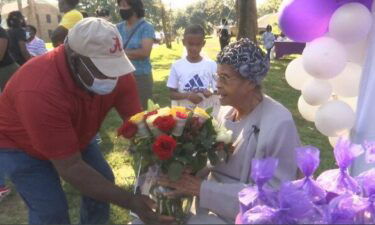 Mrs. Emma Mae Washington sat front and center as parade of family and friends led by Mobile Fire-Rescue drove by.