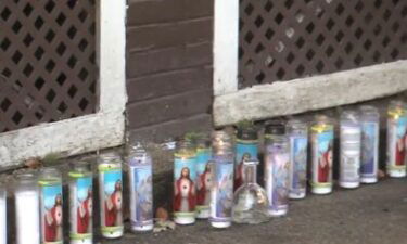 Candles sit outside of the home of Vanessa Anderson