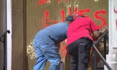 Crews clean offensive graffiti off of the Cathedral Basilica of the Immaculate Conception in Denver on October 10.
