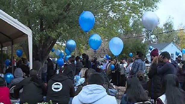 <i>KSL</i><br/>Mourners hold balloons at a gathering in the memory of Isaiah Valerio