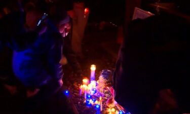 Mourners attend an October 24 candleight vigil for 5-year-old Elijah Lewis