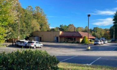 Authorities are investigating after the body of a woman was found at an abandoned Denny's restaurant off Patton Avenue.