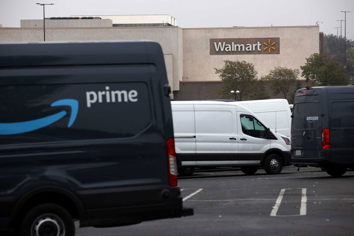 <i>Justin Sullivan/Getty Images</i><br/>Amazon Prime delivery vans sit parked near a Walmart store on September 03