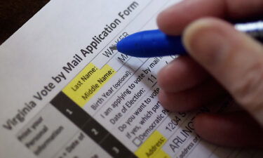 This illustration photo shows a Virginia resident filling out an application to vote by mail ahead of the November Presidential election