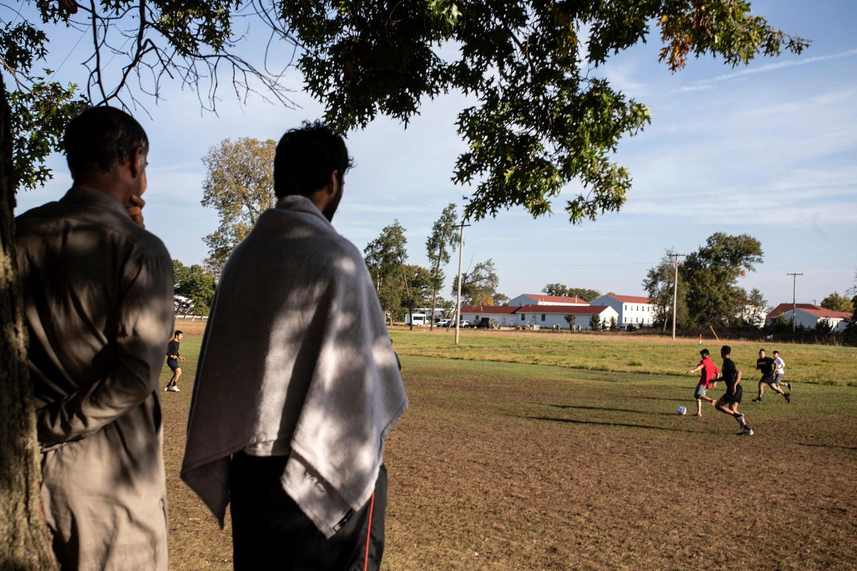 <i>BARBARA DAVIDSON/AFP/POOL/Getty Images</i><br/>Members of the U.S. military and Afghan refugees play soccer at Ft. McCoy US Army base on September 30 in Ft. McCoy