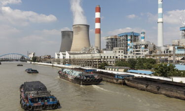 Barges travel past a power plant in Wangting