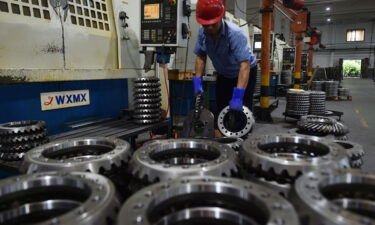 The cost of goods leaving China's factories is surging by the highest rate on record. A worker is shown here in a factory of automotive parts in Taizhou in east China's Jiangsu province Wednesday