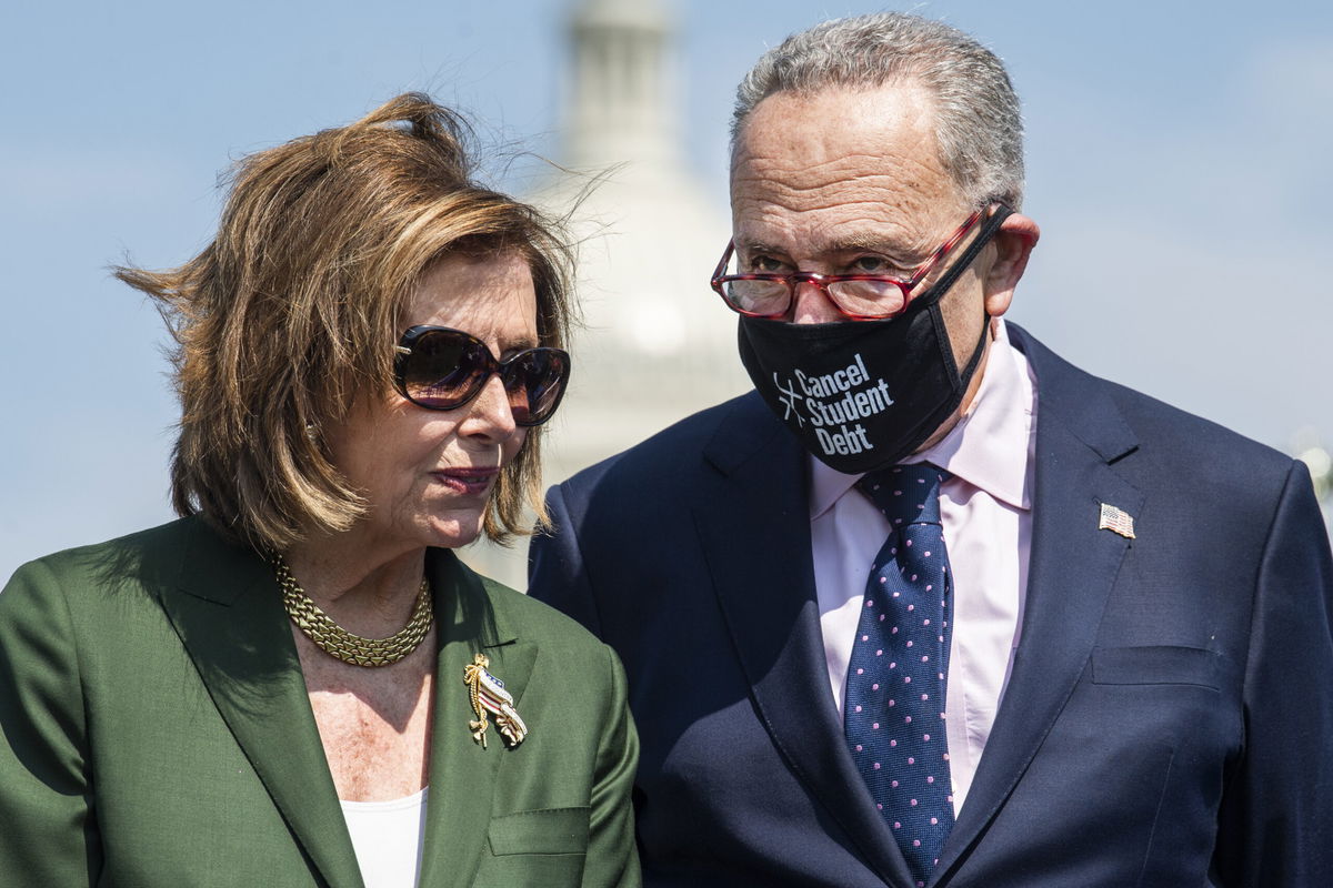 <i>Tom Williams/CQ-Roll Call/Getty Images</i><br/>The Democratic Party's effort to finalize a sweeping economic package will be front-and-center on Capitol Hill this week. Speaker of the House Nancy Pelosi and Senate Majority Leader Charles Schumer are shown here attending a rally near the Capitol Reflecting Pool on Wednesday