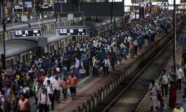 Commuters wait for local trains during peak hours at Chhatrapati Shivaji Maharaj Terminus in Mumbai on September 30