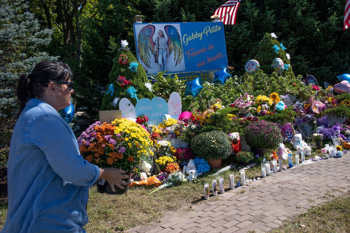 <i>Andrew Lichtenstein/Corbis News/Getty Images</i><br/>Authorities are scheduled to provide an update on Gabby Petito's final autopsy report. Members of the public leave flowers at a memorial site for Gabby Petito on September 26