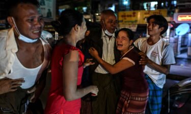 A man is reunited with his family members following his release outside Insein Prison in Yangon