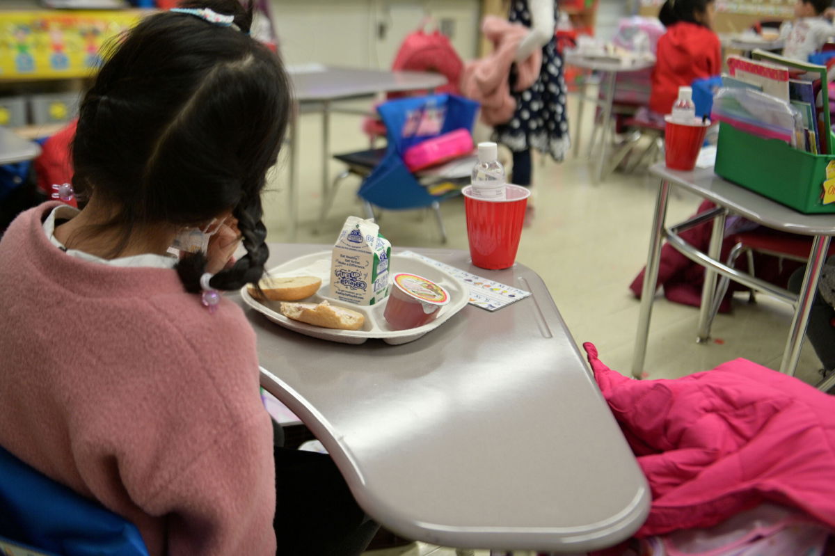 <i>Michael Loccisano/Getty Images</i><br/>A kindergarten student eats breakfast at Yung Wing School P.S. 124 in New York City earlier this year.