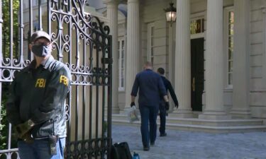 FBI agents are shown here at the Washington home of Russian oligarch Oleg Deripaska.