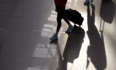 Two young men walk through Terminal 1 with their suitcases on June 25 2021 in Hamburg