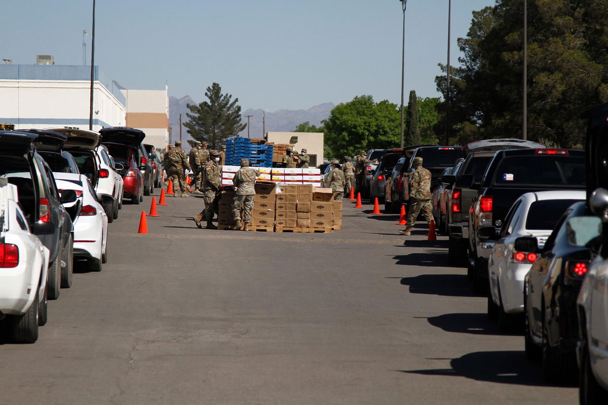 <i>Cedar Attanasio/AP</i><br/>Texas National Guard soldiers distribute food at the El Pasoans Fighting Hunger Food Bank