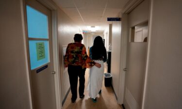 A 33-year-old mother of three from central Texas is escorted down the hall by the clinic administrator prior to getting an abortion