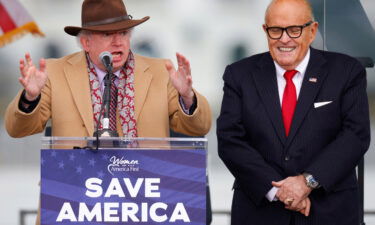 Attorney John Eastman gestures as he speaks next to then-US President Donald Trump's personal attorney Rudy Giuliani