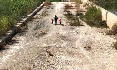 A US Border Patrol agent is seen walking with two young sisters found on October 12