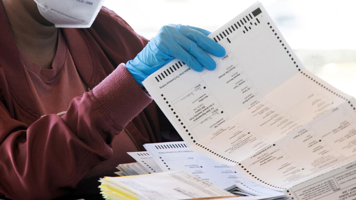 <i>Jessica McGowan/Getty Images/FILE</i><br/>An election worker counts Fulton County ballots on November 4