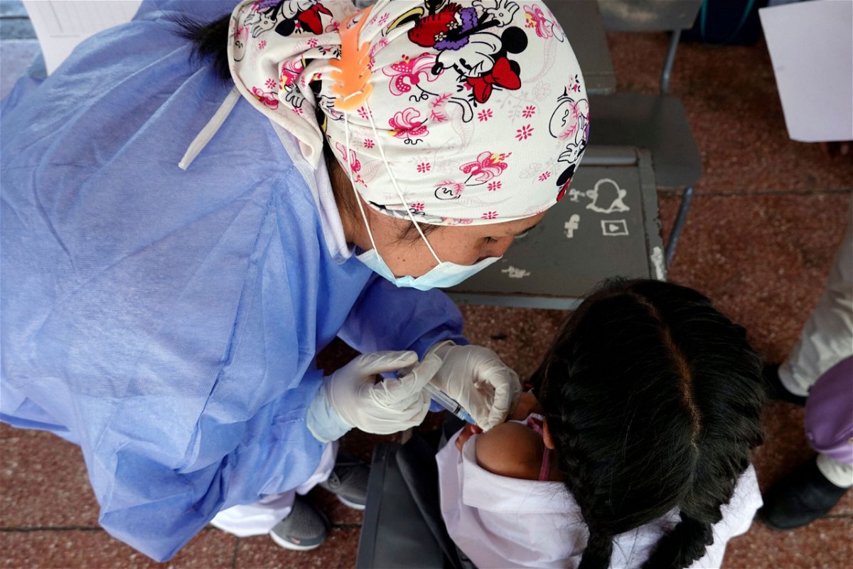 <i>Rodgrigo Buendia/AFP/Getty Images</i><br/>Prepare ahead of time so you can ease your child's fears about getting vaccinated.  A child receives the Covid-19 vaccine in Quito