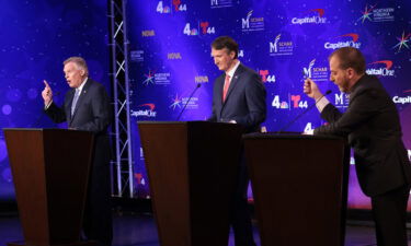 Former Democrat Virginia Gov. Terry McAuliffe (L) and Republican gubernatorial candidate Glenn Youngkin (C) participate in a debate hosted by the Northern Virginia Chamber of Commerce September 28