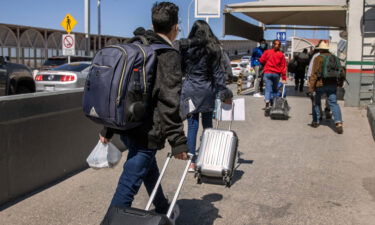 The Biden administration is preparing to revive in mid-November a Trump-era border policy that forces migrants to stay in Mexico until their US immigration court date. Asylum seekers are shown here crossing an international bridge from Mexico into the United States on March 17