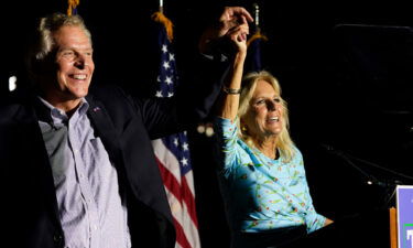 First lady Jill Biden laughs with Democratic gubernatorial candidate Terry McAuliffe during a rally in Richmond