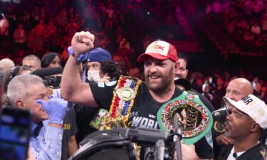 Tyson Fury wears his championship belts after defeating Wilder earlier this year.